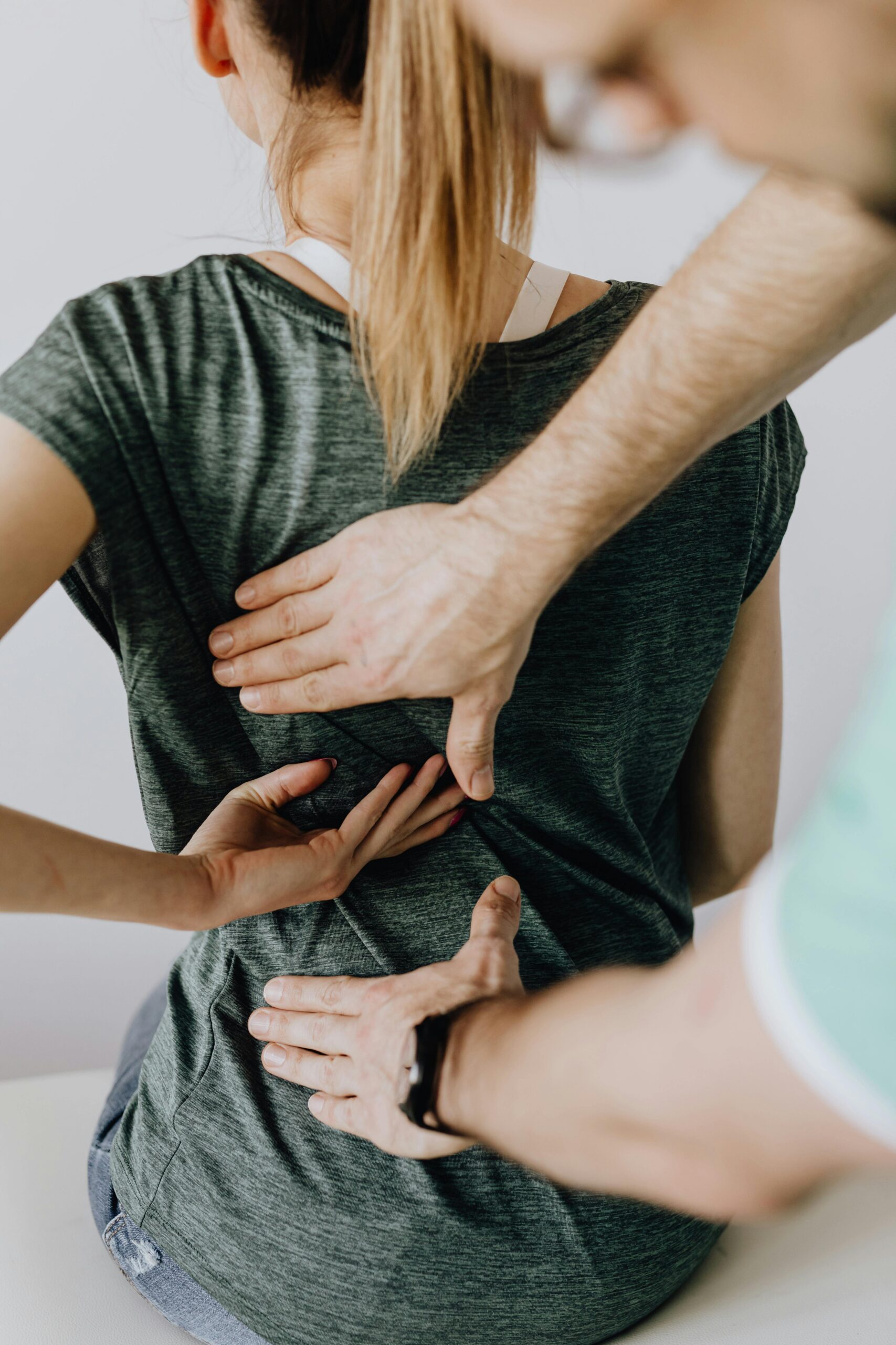 Chiropractor performs manual adjustment on a patient's back to alleviate discomfort and improve posture.